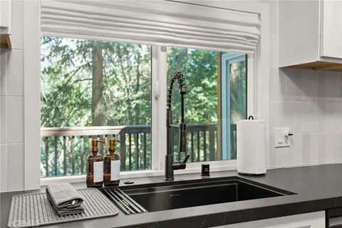 a view of a balcony with wooden floor and furniture