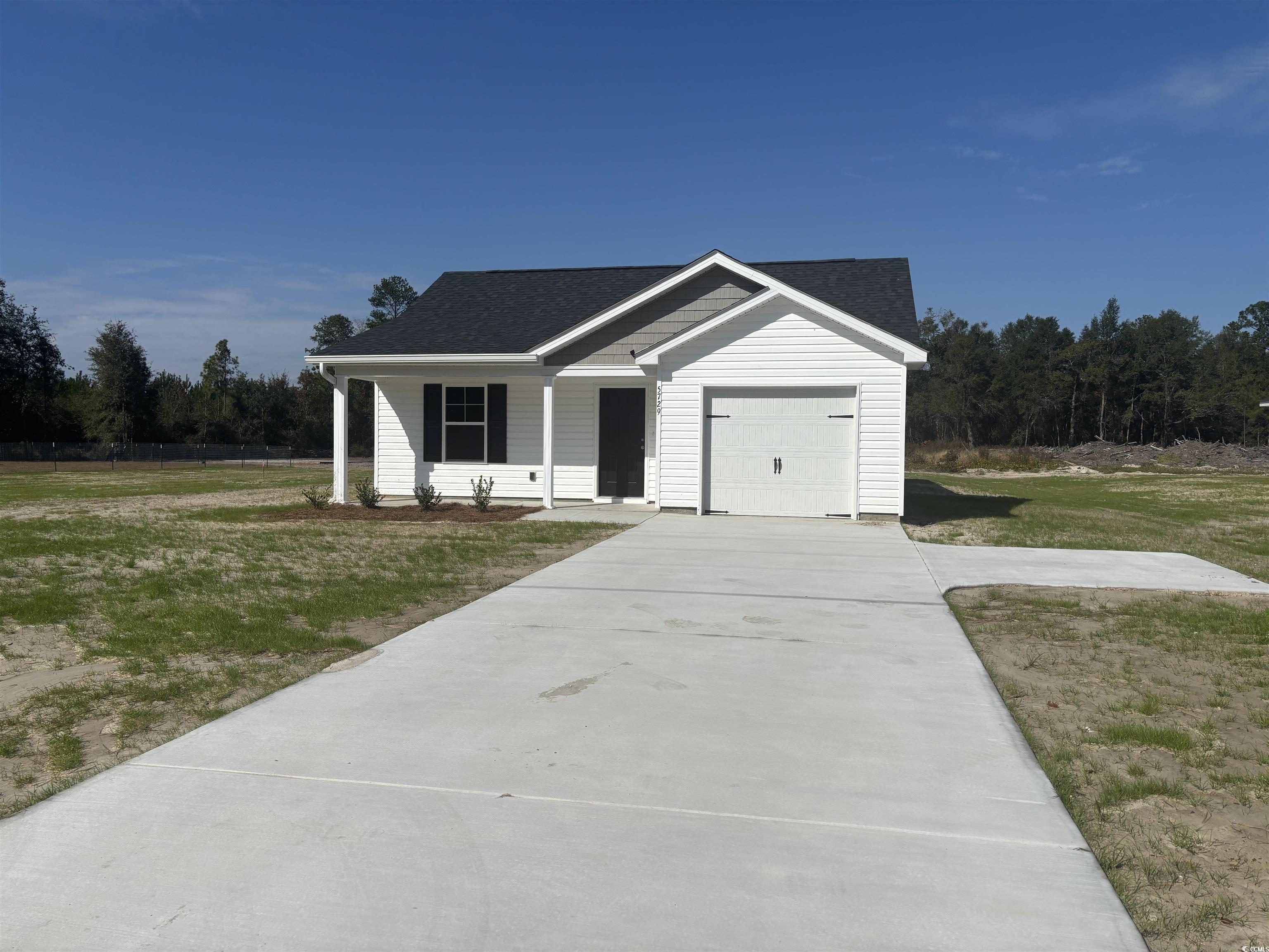 5729 Highway 41 Marion, SC 29571 - Photo 1 of 8 Ranch-style home with a shingled roof, a front lawn, a porch, and driveway