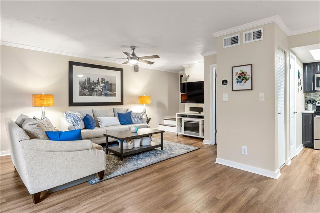 307 Adair Street, Unit D7 Decatur, GA 30030 - Photo 1 of 1 a living room with furniture flat screen tv and wooden floor