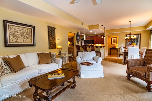 a living room with furniture and a chandelier