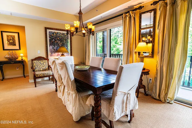 a view of a dining room with furniture and a window