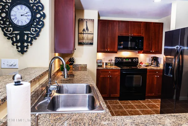 a kitchen with a sink cabinets and stainless steel appliances