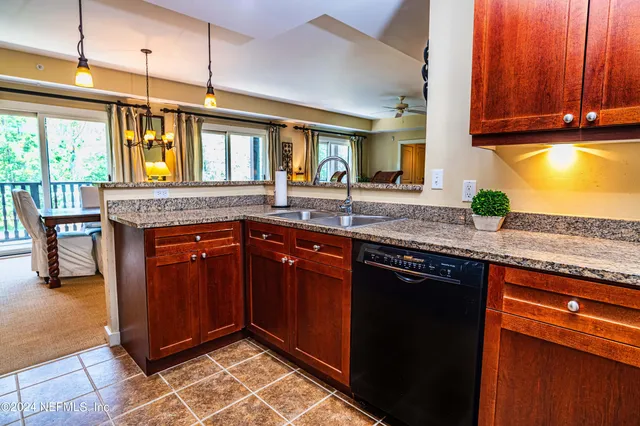 a kitchen with granite countertop cabinets and window
