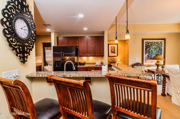 a living room with furniture a clock and a fireplace