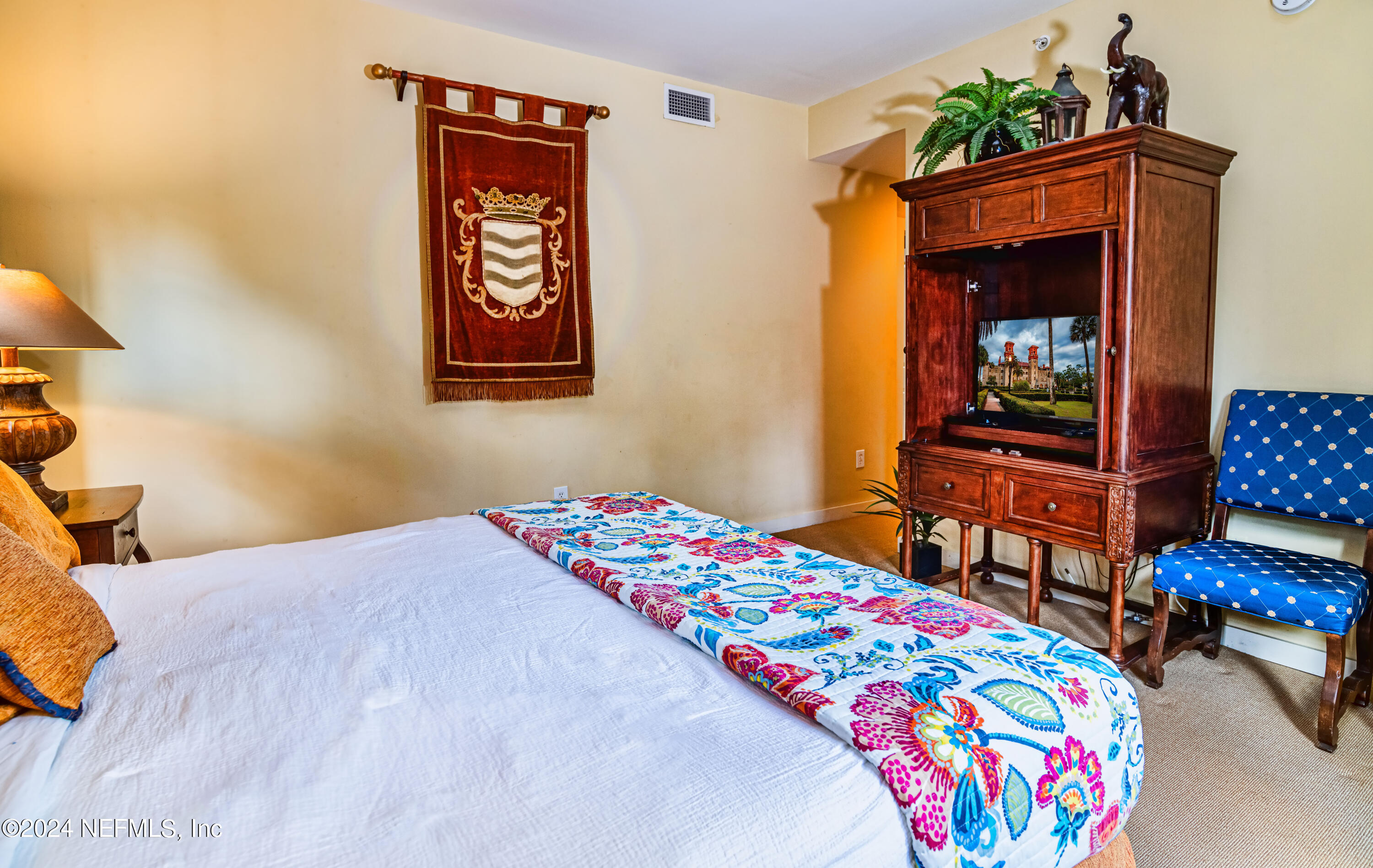 955 Registry Boulevard, Unit 229 St. Augustine, FL 32092 - Photo 20 of 36 a bedroom with a bed and a dresser in it