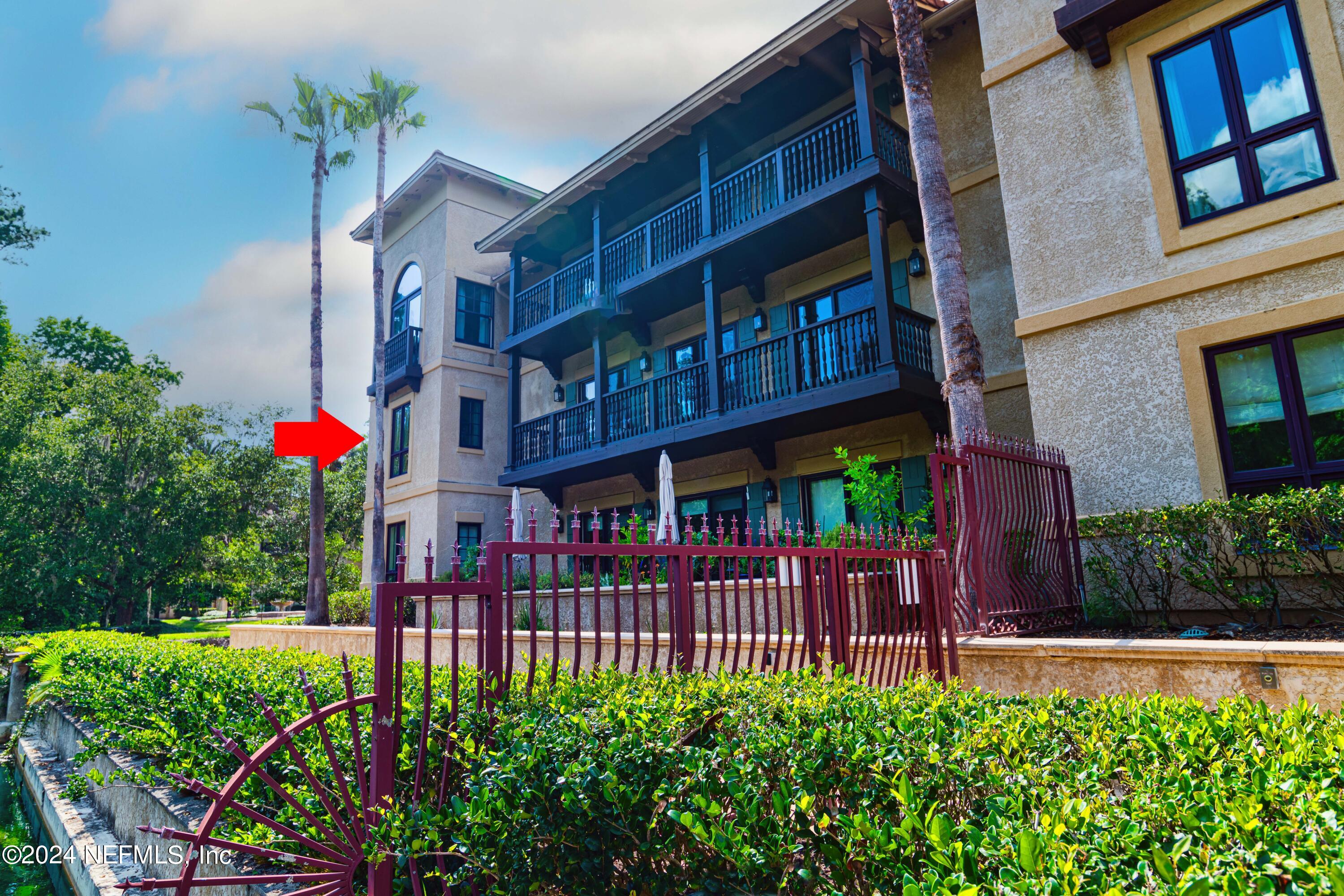955 Registry Boulevard, Unit 229 St. Augustine, FL 32092 - Photo 31 of 36 a view of a brick house with large windows and flower plants