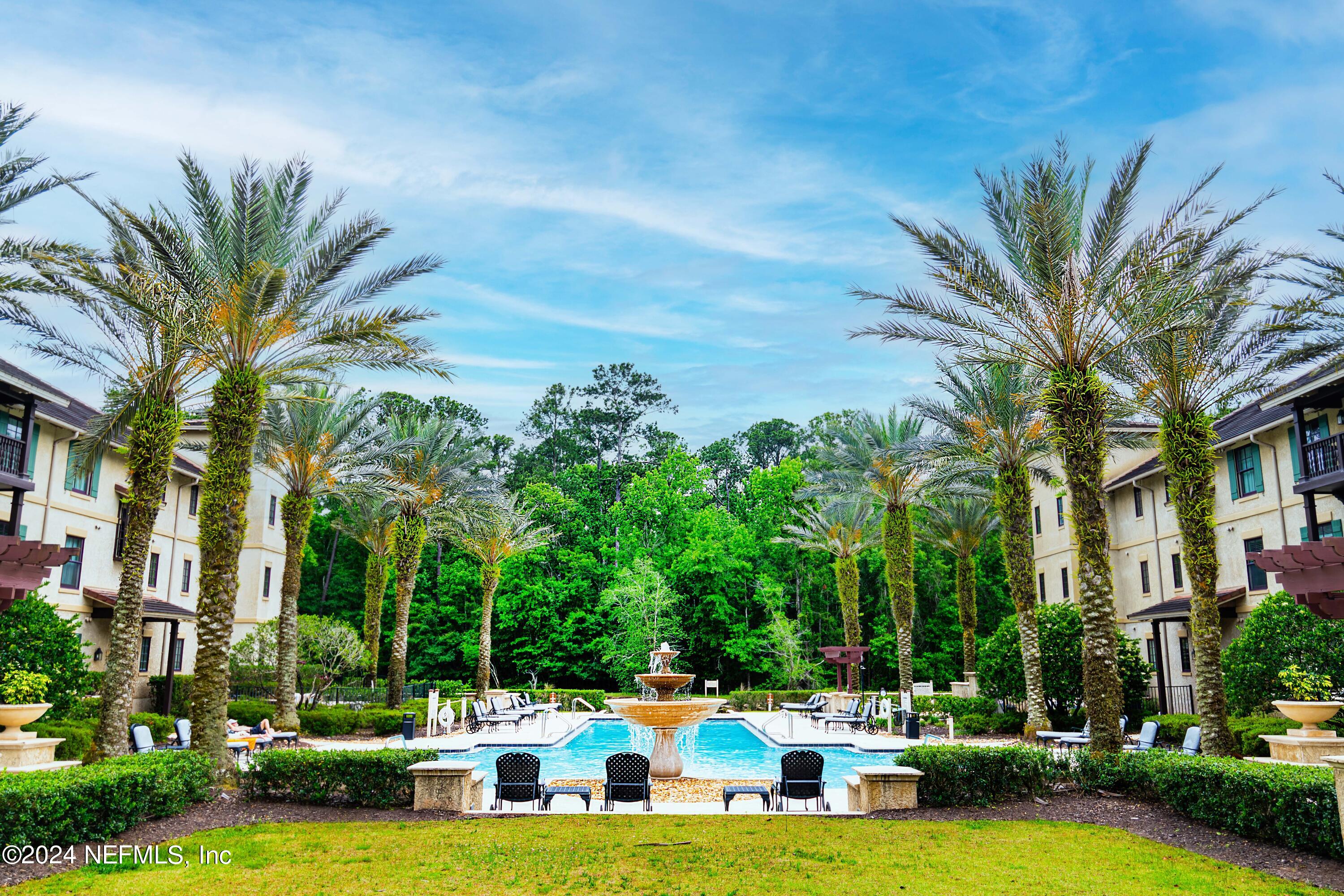 955 Registry Boulevard, Unit 229 St. Augustine, FL 32092 - Photo 32 of 36 a view of a swimming pool with lawn chairs and a big yard