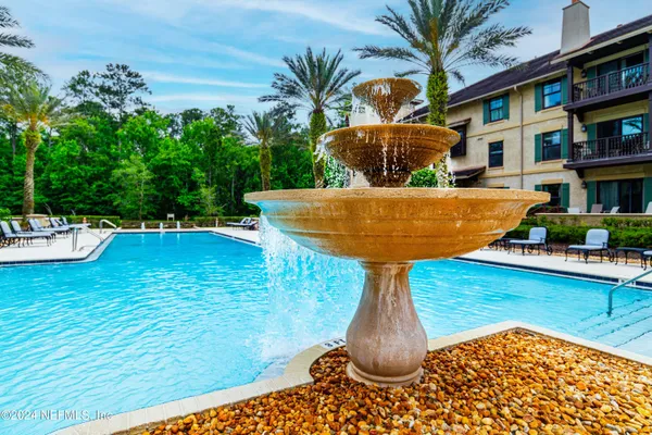 a view of a swimming pool with a yard