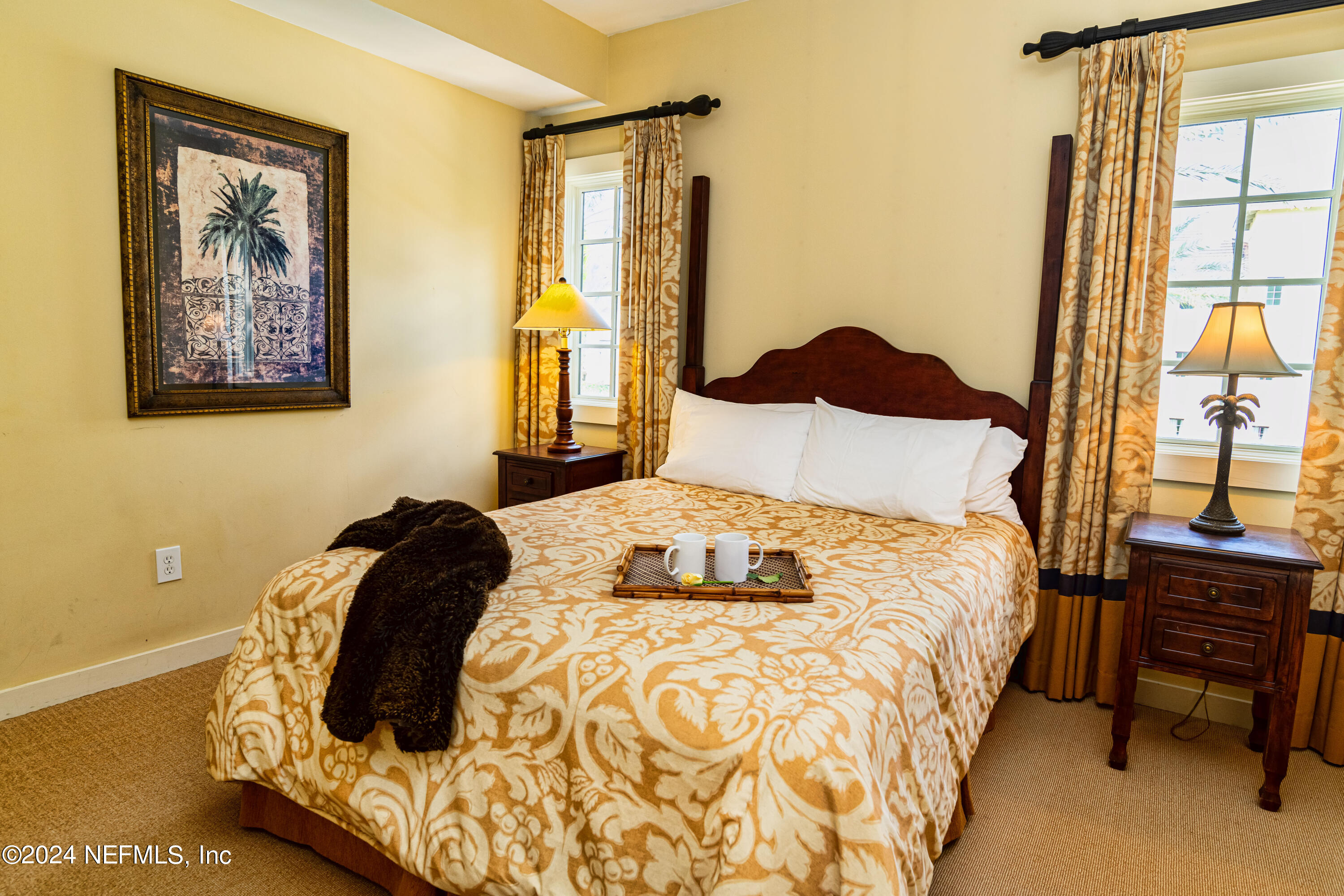 955 Registry Boulevard, Unit 229 St. Augustine, FL 32092 - Photo 9 of 36 a bedroom with a bed and wooden floor