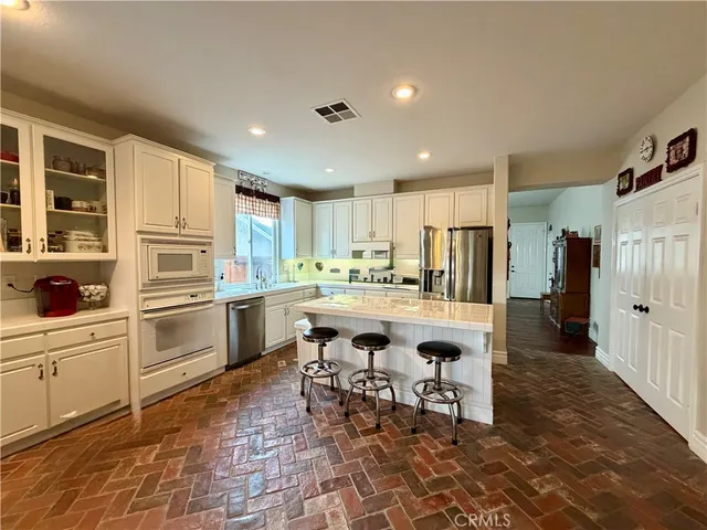 a kitchen with a sink and chairs