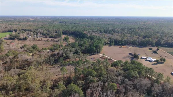 an aerial view of a house with yard