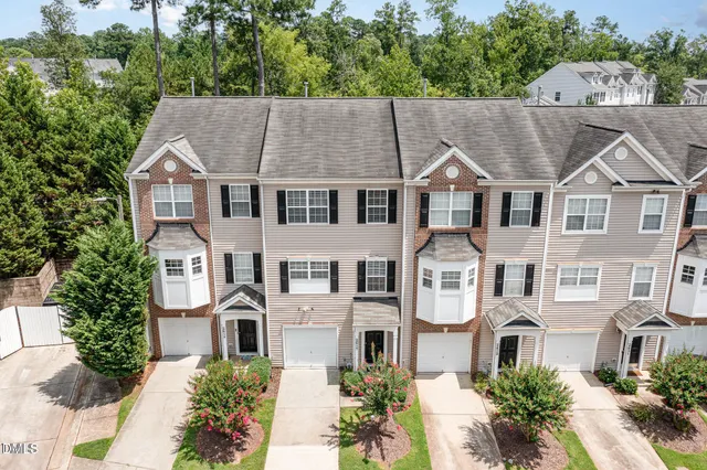 an aerial view of a residential apartment building with a yard
