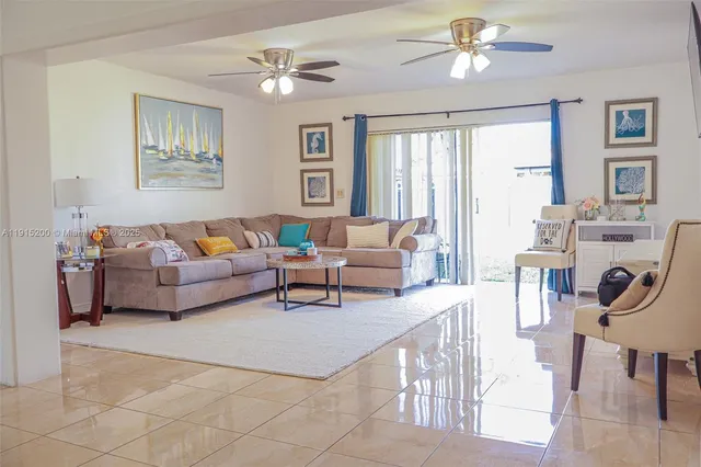 a living room with furniture a table and a window