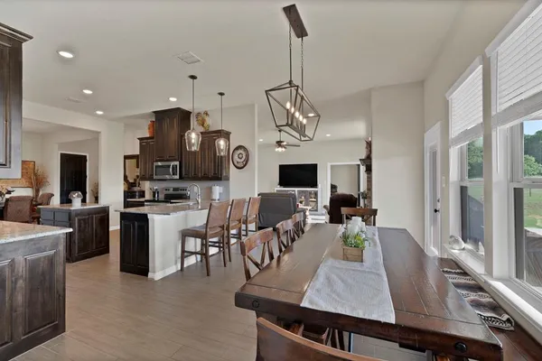 a large kitchen with a table and chairs