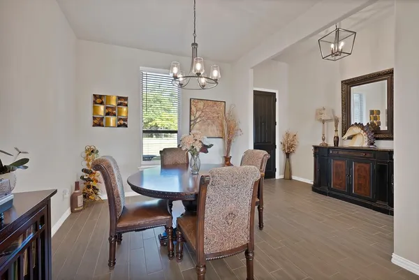 a view of a dining room with furniture window and wooden floor