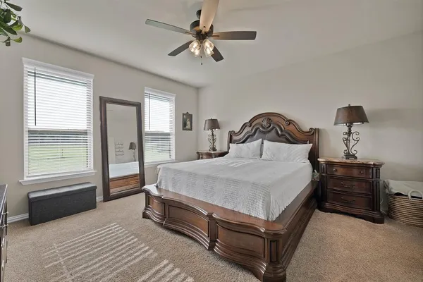a bedroom with a bed and a chandelier
