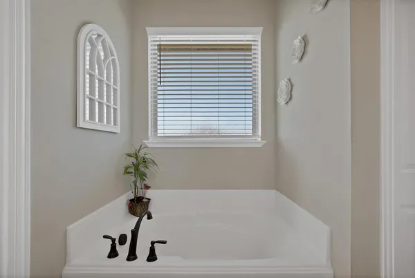 a bathroom with a bathtub and shower