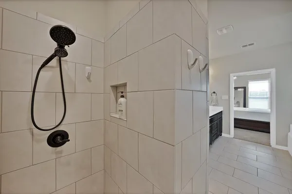 a bathroom with a shower and mirror