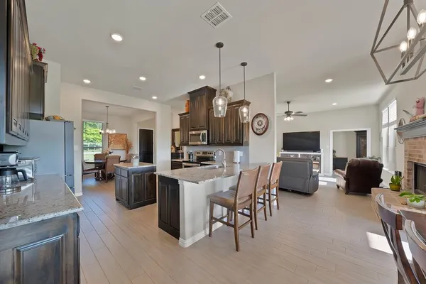 a large kitchen with a table and chairs
