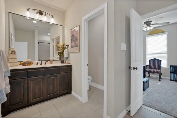 a spacious bathroom with a double vanity sink and a mirror