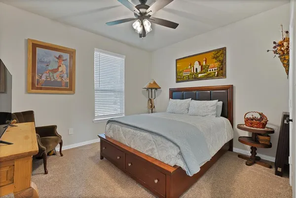 a spacious bedroom with a bed and a desk