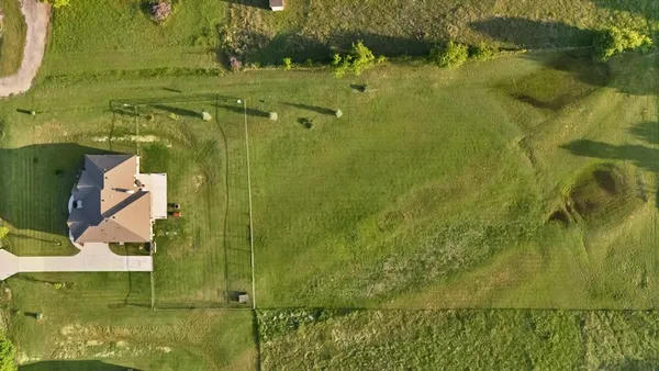 an aerial view of residential houses with pool