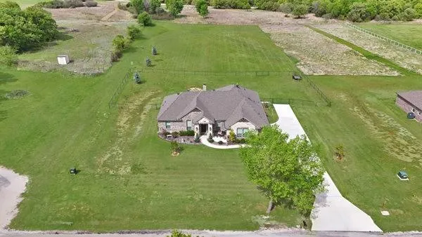 an aerial view of a house with a yard basket ball court and outdoor seating