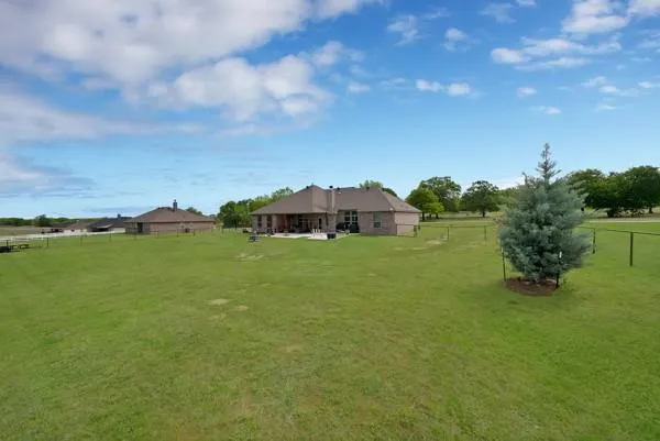 a view of a house with a yard and sitting area