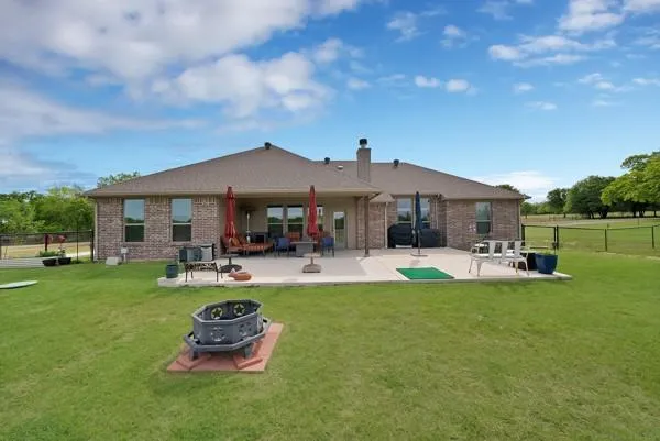 a front view of a house with swimming pool garden and outdoor seating