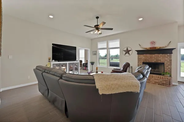 a living room with fireplace furniture and a flat screen tv
