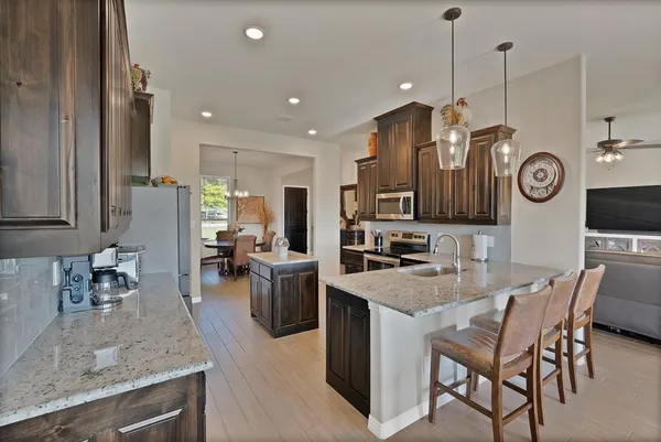 a kitchen with a table and chairs in it