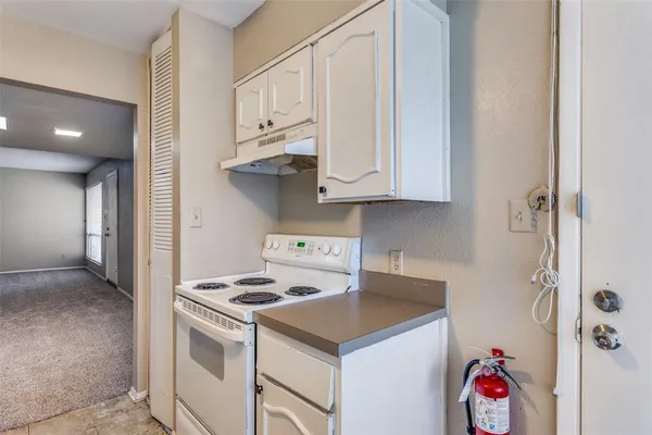 a kitchen with stainless steel appliances white cabinets and a sink