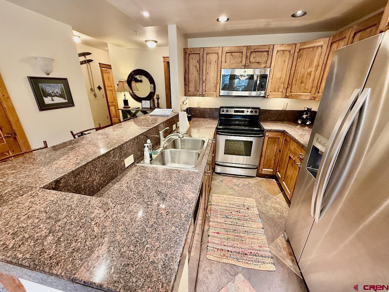 9 Hunter Hill Road, Unit 205 Crested Butte, CO 81225 - Photo 6 of 28 a kitchen with sink and cabinets