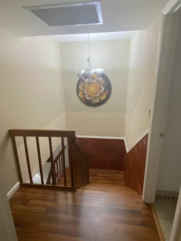 a bathroom with a toilet sink vanity and mirror