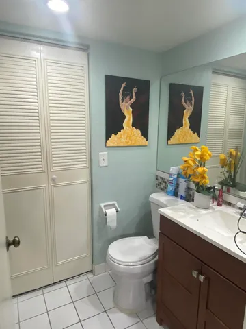 a patio with table and chairs and potted plants