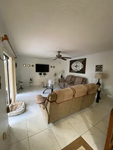 a bedroom with a large bed and chandelier