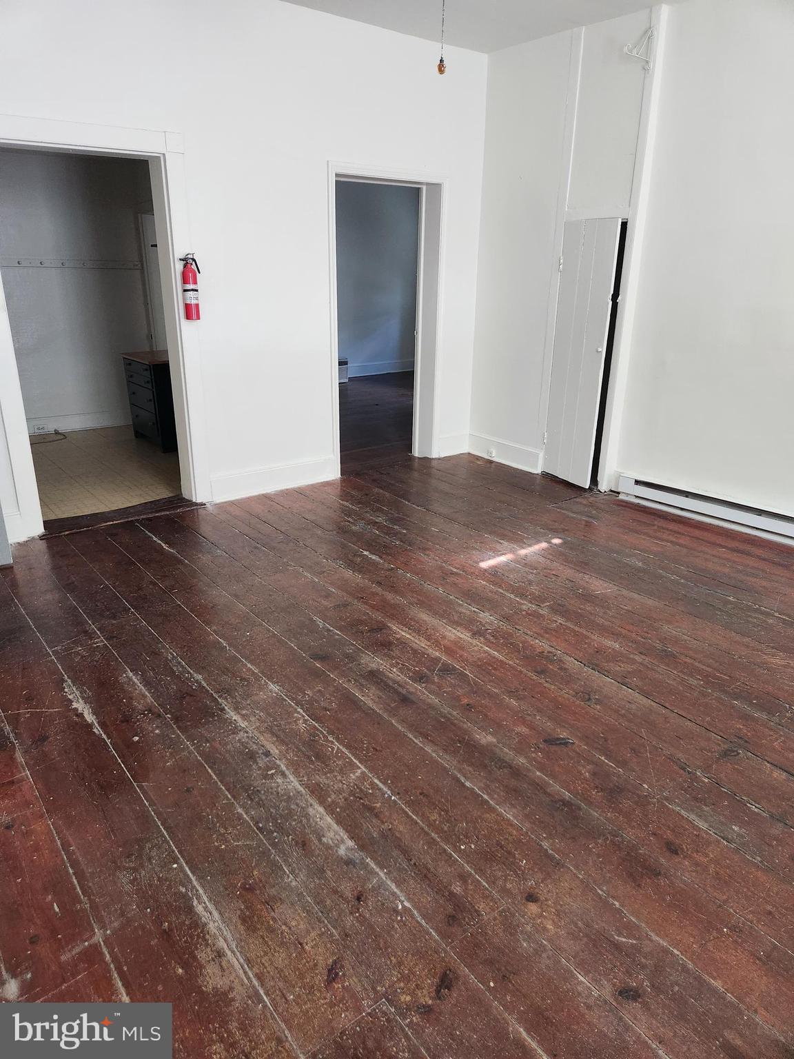 114 South Princess Street, Unit 1 Shepherdstown, WV 25443 - Photo 3 of 10 a view of an empty room with wooden floor and a window