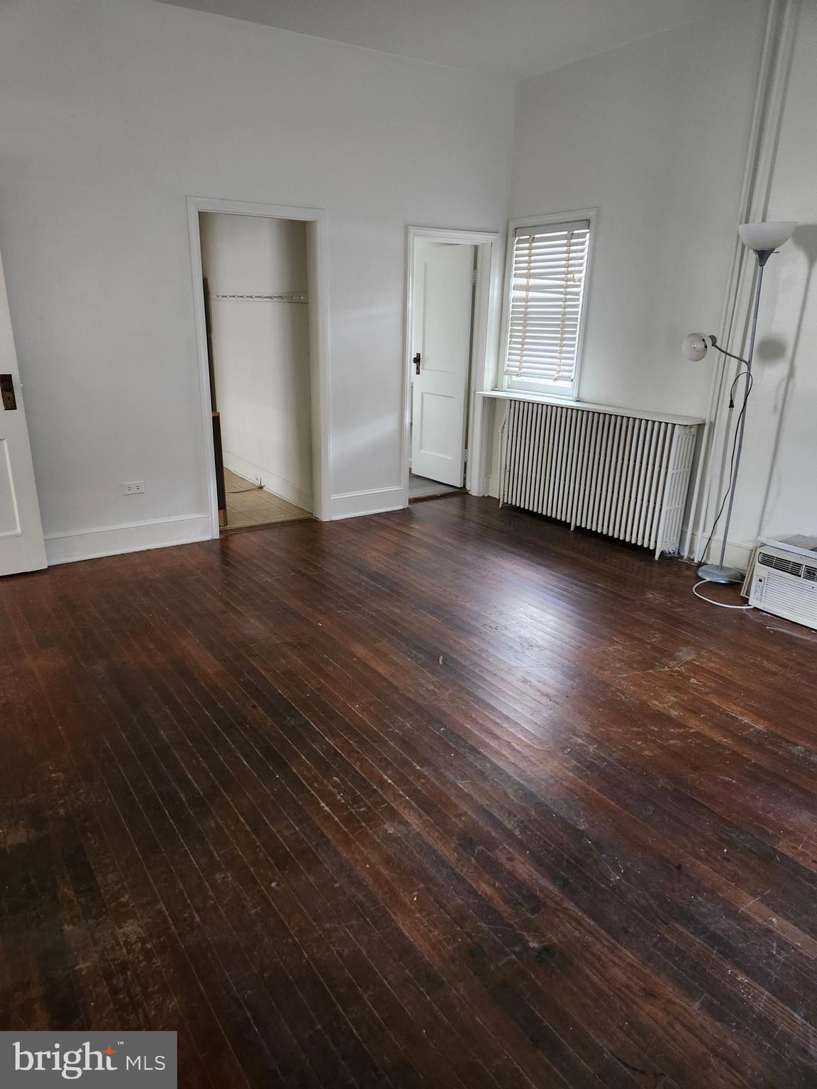 114 South Princess Street, Unit 1 Shepherdstown, WV 25443 - Photo 5 of 10 an empty room with wooden floor and windows