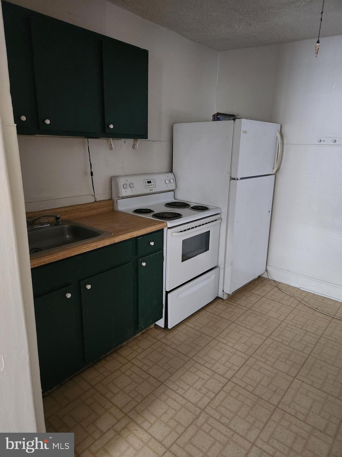 114 South Princess Street, Unit 1 Shepherdstown, WV 25443 - Photo 7 of 10 a kitchen with a sink a stove and a refrigerator