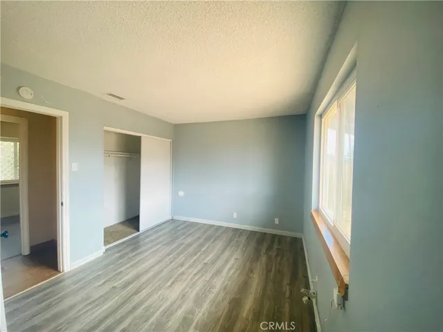 a bathroom with a granite countertop shower sink mirror and toilet