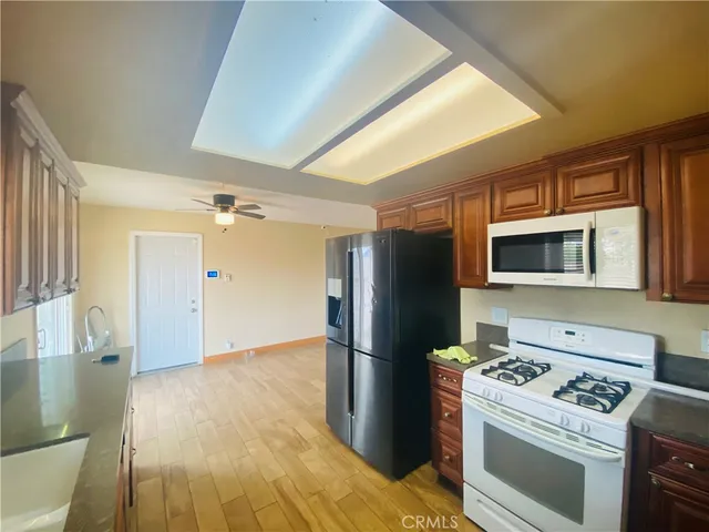 a kitchen with a stove refrigerator and a sink
