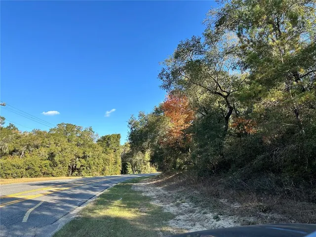 a view of a field with an trees