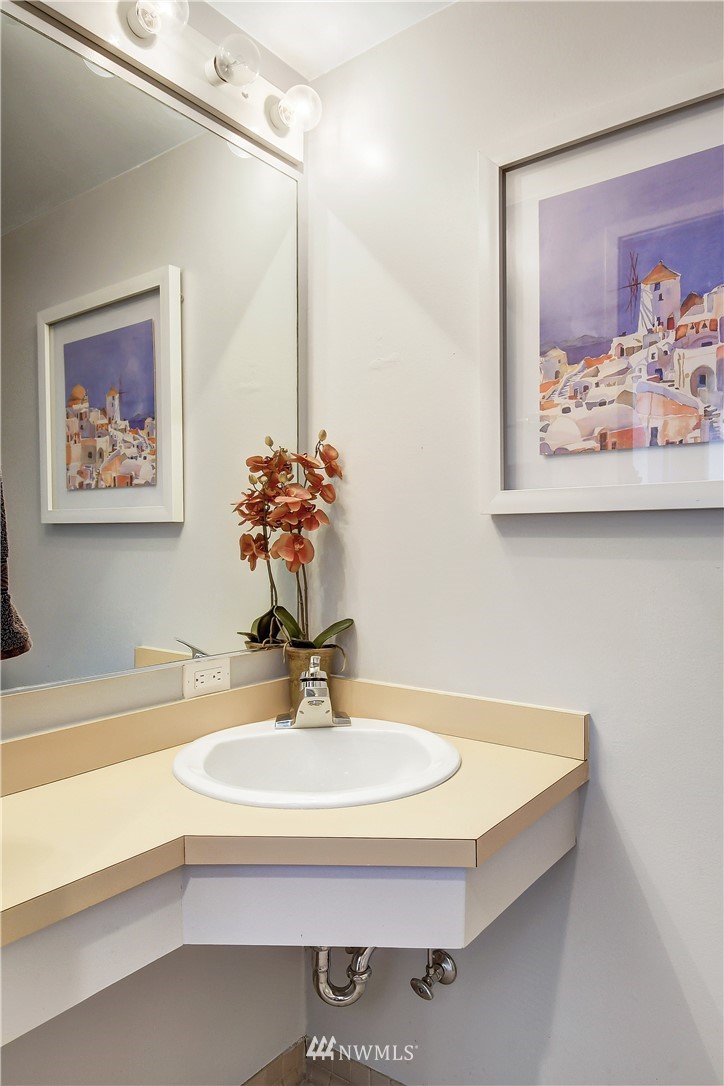 2125 1st Avenue, Unit 1702 Seattle, WA 98121 - Photo 11 of 31 a bathroom with a sink and a mirror