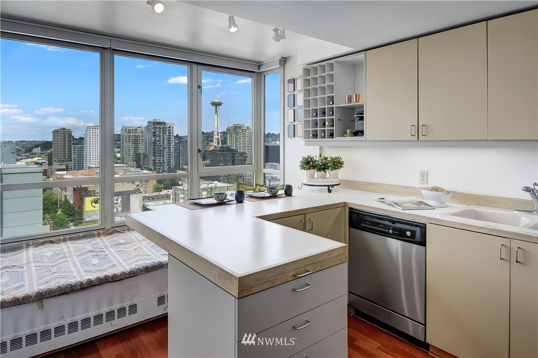 2125 1st Avenue, Unit 1702 Seattle, WA 98121 - Photo 8 of 31 a open kitchen with granite countertop a sink and a stove