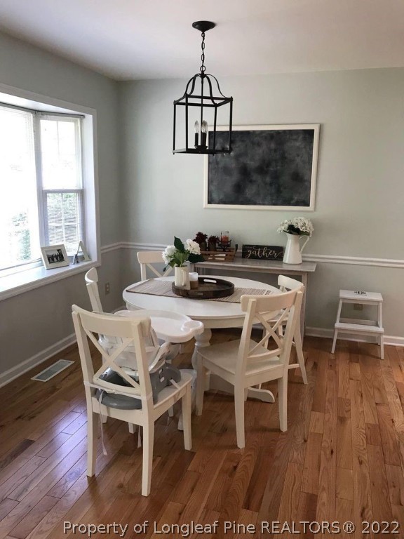 21 Princess Gate Whispering Pines, NC 28327 - Photo 13 of 33 a view of a dining room with furniture window and wooden floor