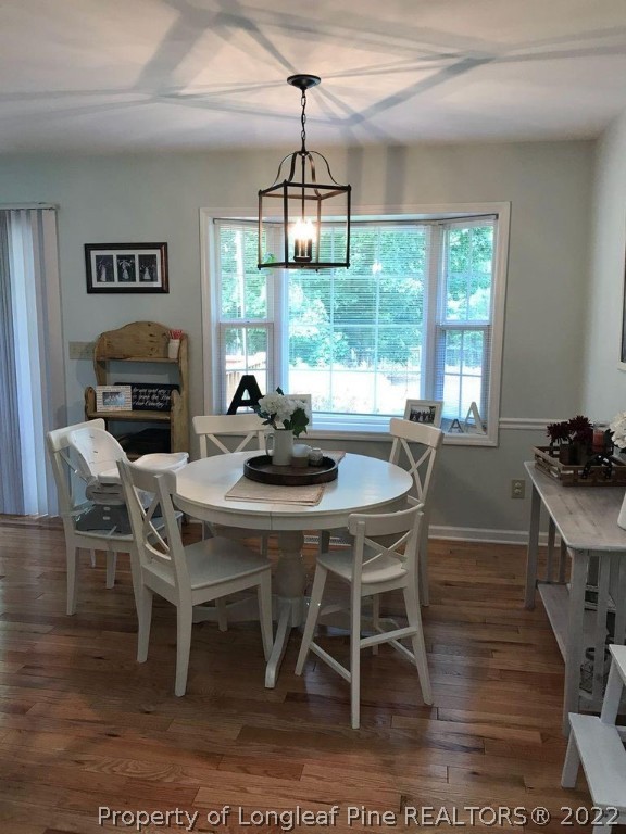 21 Princess Gate Whispering Pines, NC 28327 - Photo 14 of 33 a dining room with furniture a chandelier and wooden floor