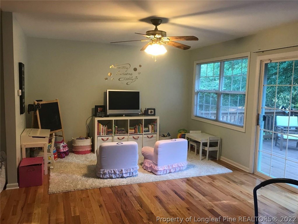 21 Princess Gate Whispering Pines, NC 28327 - Photo 15 of 33 a living room with furniture a flat screen tv and a fireplace
