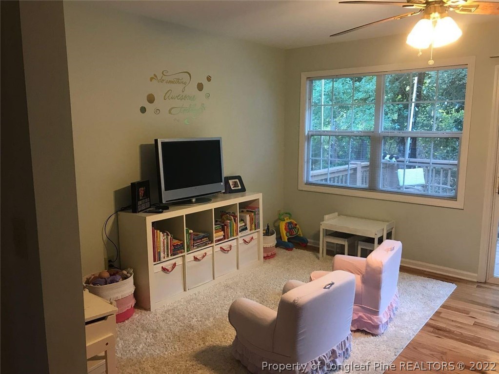 21 Princess Gate Whispering Pines, NC 28327 - Photo 18 of 33 a living room with furniture a window and a flat screen tv