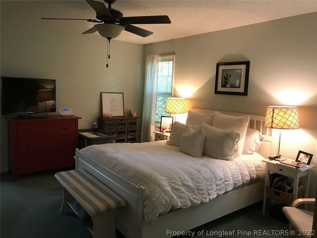 21 Princess Gate Whispering Pines, NC 28327 - Photo 19 of 33 a bedroom with a bed and wooden floor