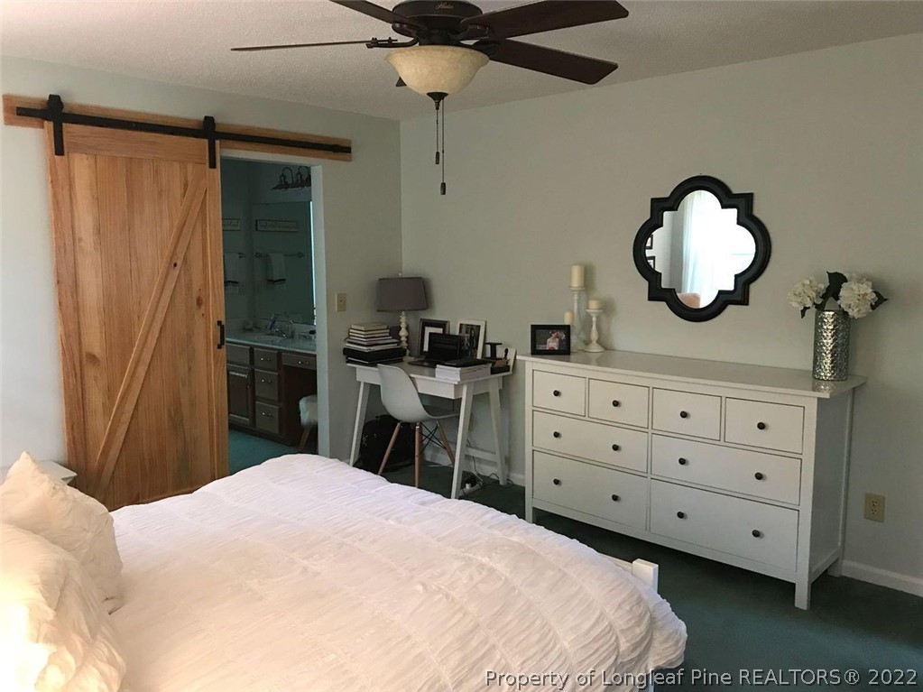 21 Princess Gate Whispering Pines, NC 28327 - Photo 20 of 33 a bedroom with a bed a dresser and a mirror